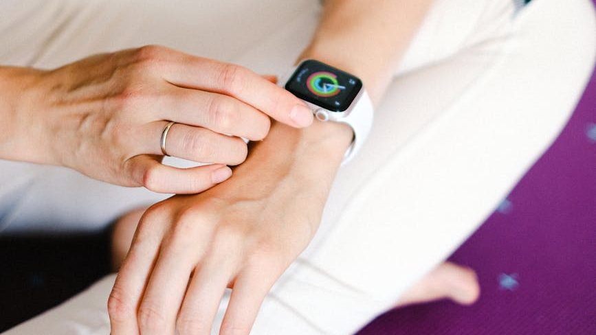 person wearing apple watch, utilizing it to track time for their workplace